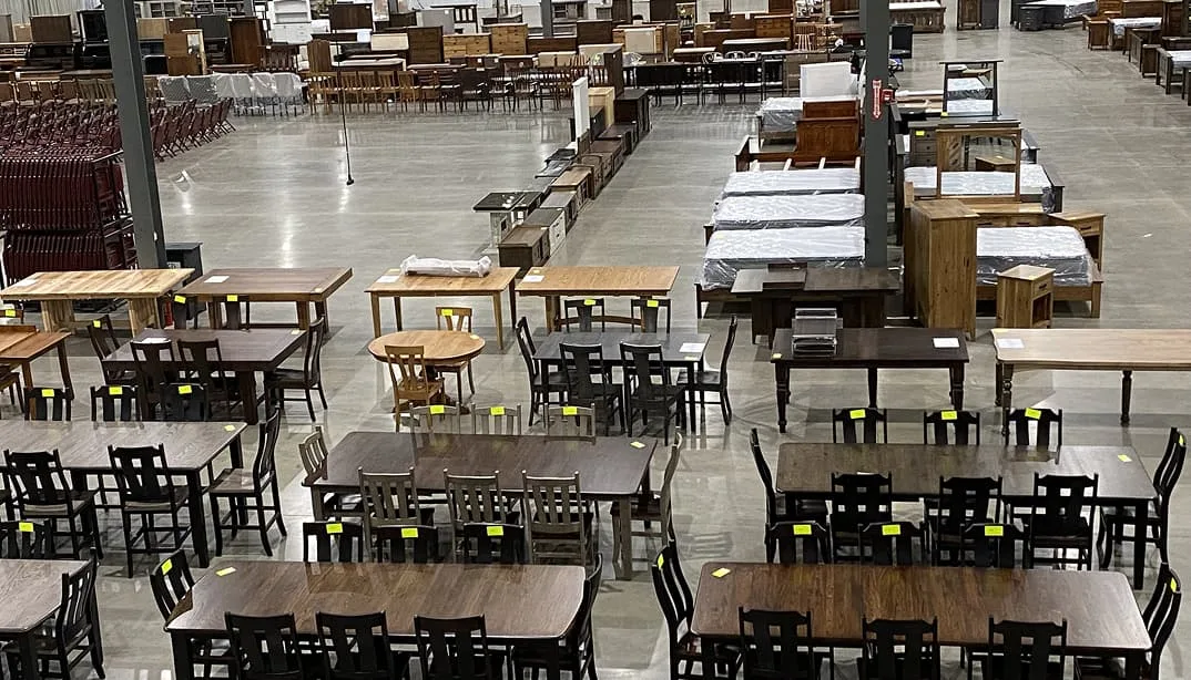 Auction with various tables and chairs displayed.